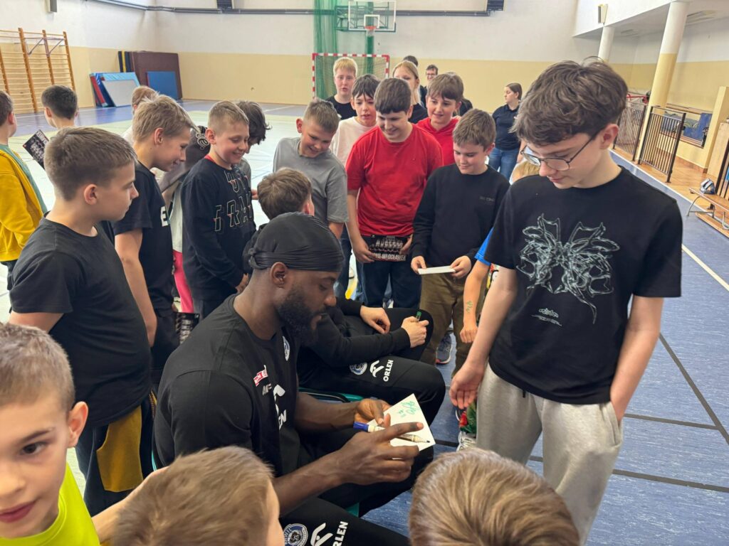 koszykarze Anwilu dający uczniom autografy